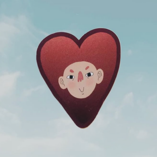 Heart-shaped object with a face illustration against a light blue sky background